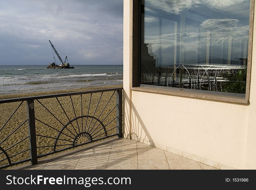 It was a sunny day on the beach and i took this particular photo where we can see clouds reflected on the glass of a bar. It was a sunny day on the beach and i took this particular photo where we can see clouds reflected on the glass of a bar.