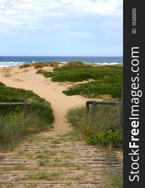Wooden pathway over sand to preserve coastal sand dune and environment. Wooden pathway over sand to preserve coastal sand dune and environment