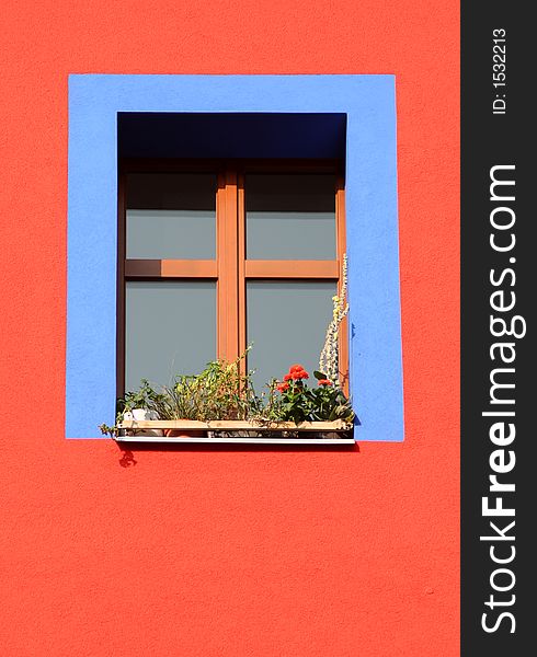 Blue window frame on red house