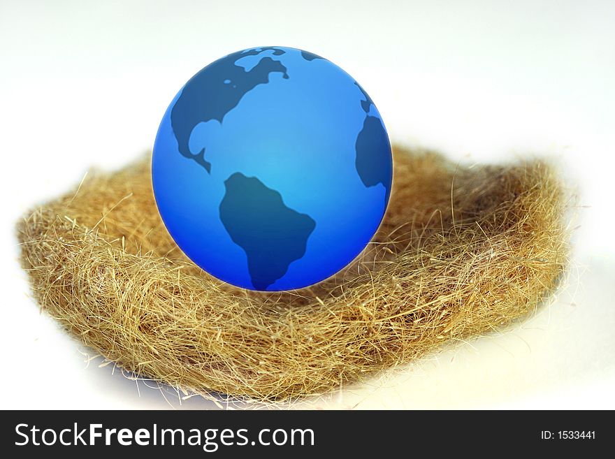 world globe nestled into a birds nest. world globe nestled into a birds nest
