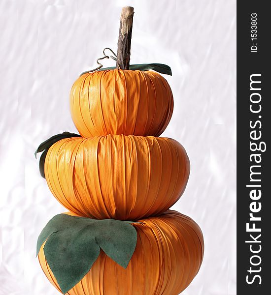 Fall decor of pumpkins - three stacked high over white. Fall decor of pumpkins - three stacked high over white