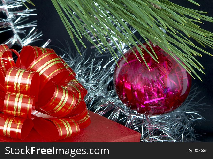 Close up of gift box, christmas ball and tinsel