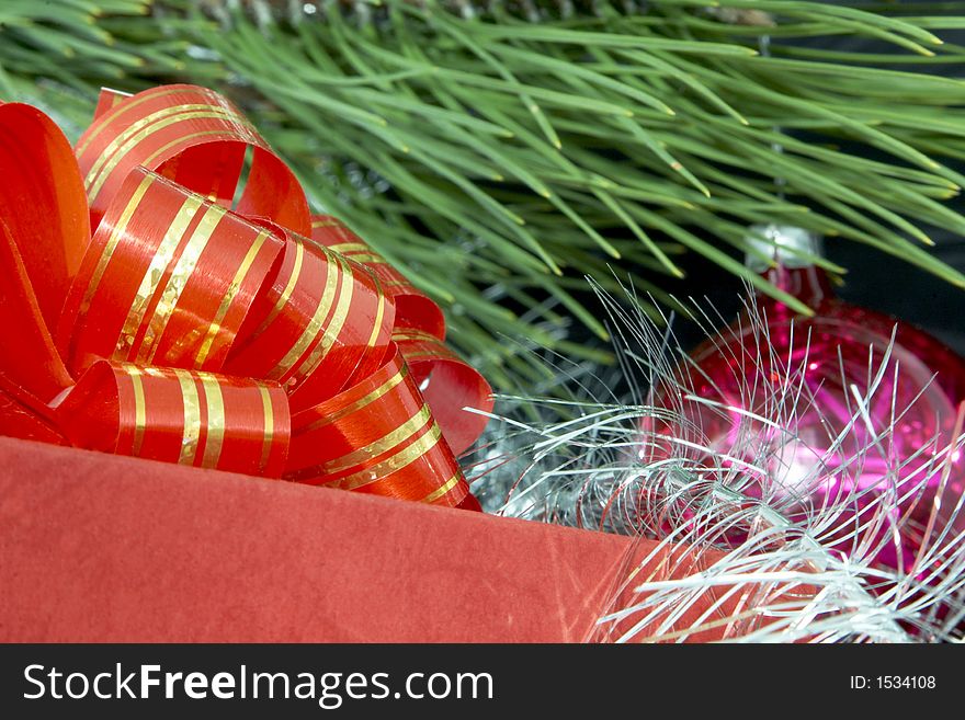 Close up of gift box, christmas ball and silver tinsel