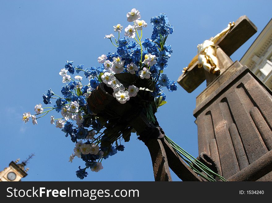 Golden Jesus on crucifix against blue sky