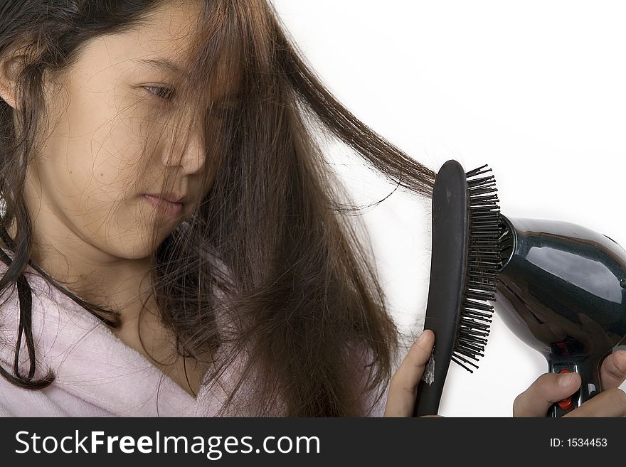 Young teenager brushes her hair. Young teenager brushes her hair
