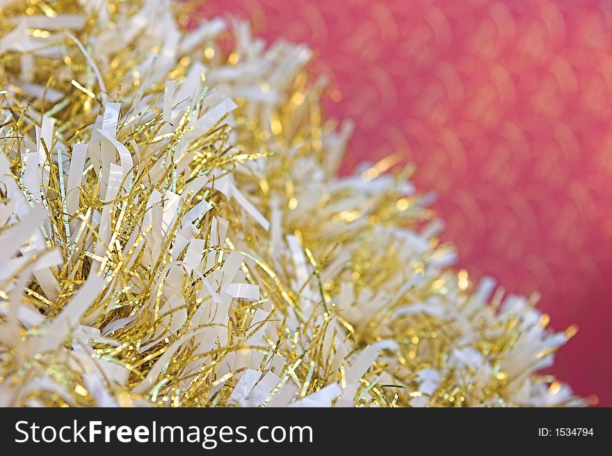 Christmas tinsel against a red background. Christmas tinsel against a red background