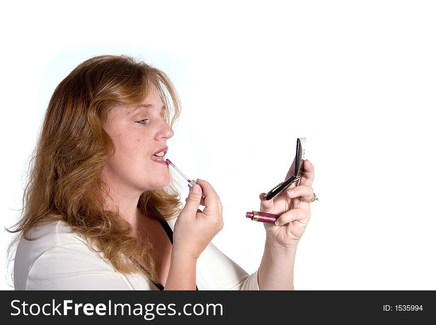 Lady applying lipstick using a compact makeup kit