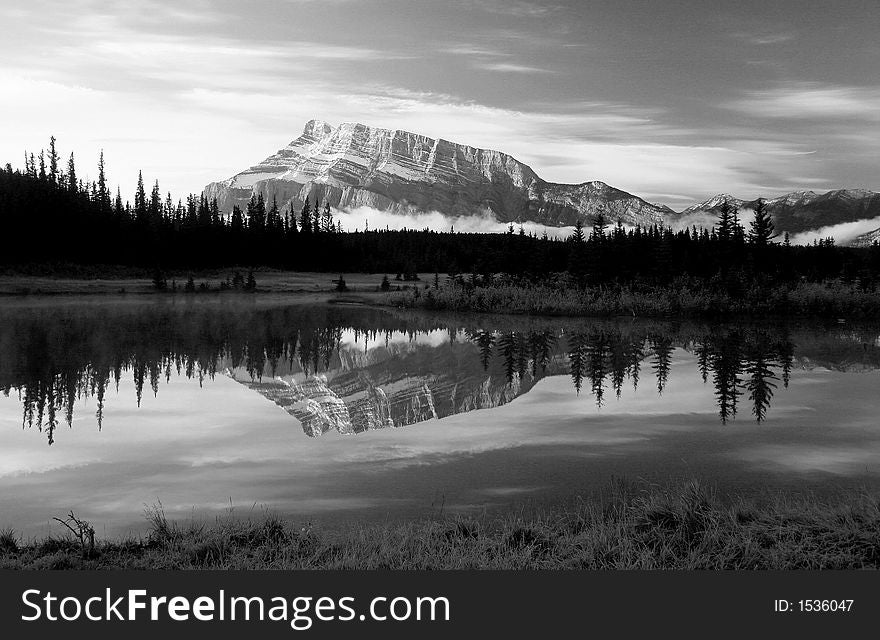 Mt Rundle and its reflectio with low lying fog seen from Cascades Pond. Mt Rundle and its reflectio with low lying fog seen from Cascades Pond.
