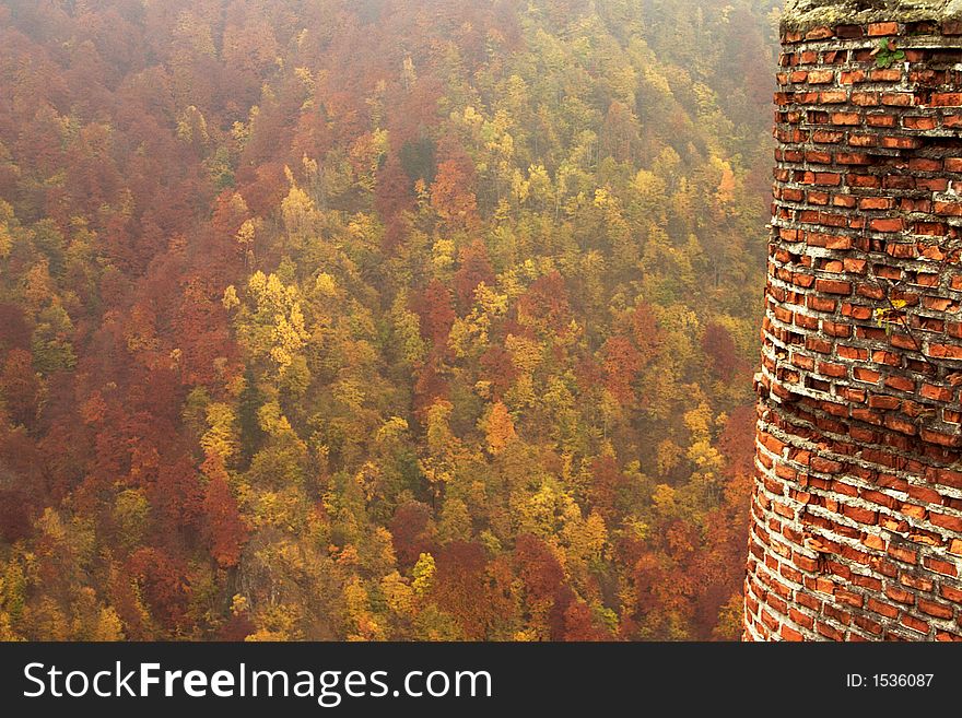 Forest and brick tower in autumn on Transfaragasan road climbing at 2034 m high in Fagaras Mountains. Forest and brick tower in autumn on Transfaragasan road climbing at 2034 m high in Fagaras Mountains