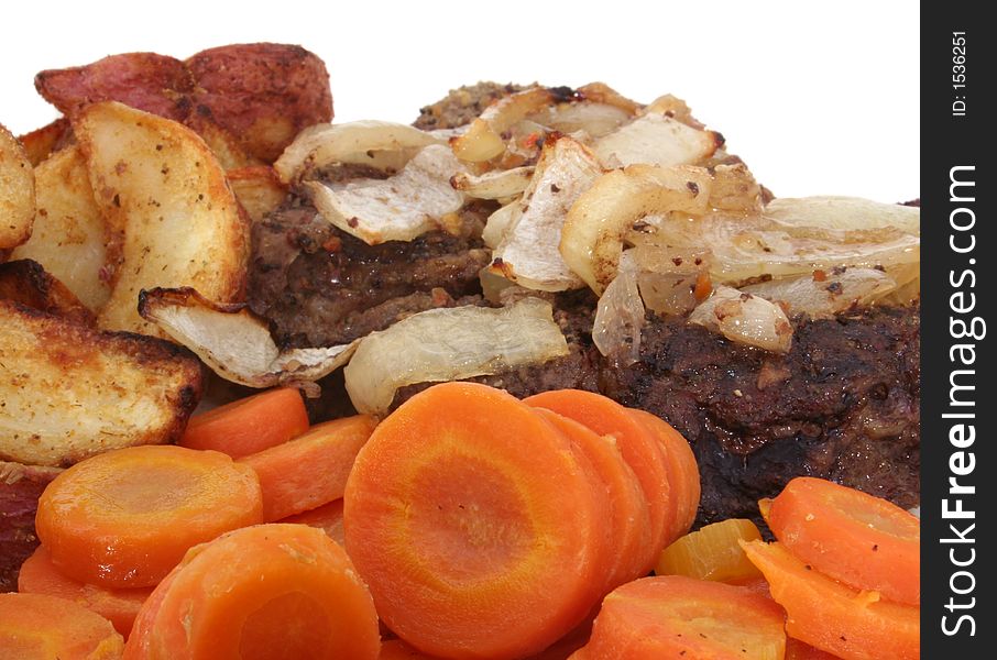 Steak with Carrots and Baked Potato Wedges on White Plate, Close-up. Steak with Carrots and Baked Potato Wedges on White Plate, Close-up