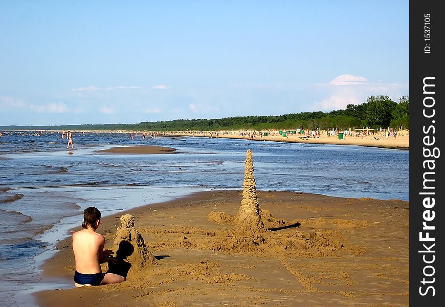 Boy Playing On A Beach