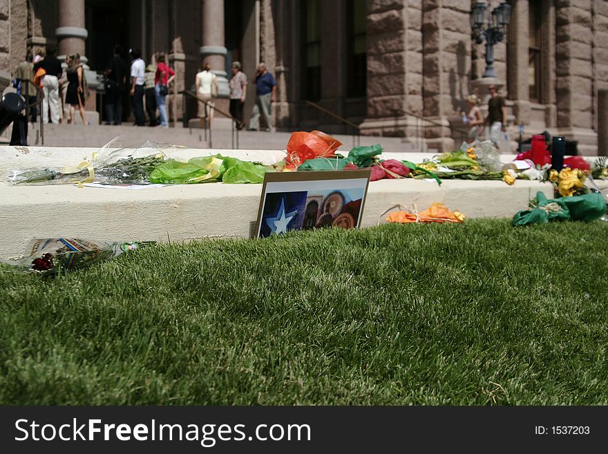 View of typical setup of remembering-the-lost event. showing in the picture is a postcard of a capitol hill in austin, texas. View of typical setup of remembering-the-lost event. showing in the picture is a postcard of a capitol hill in austin, texas