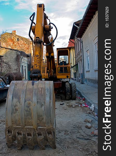 Excavator parked in a narrow street