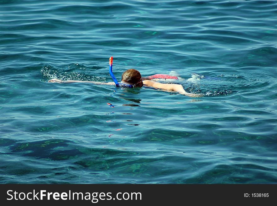 Alone boy diving in the clear sea. Alone boy diving in the clear sea