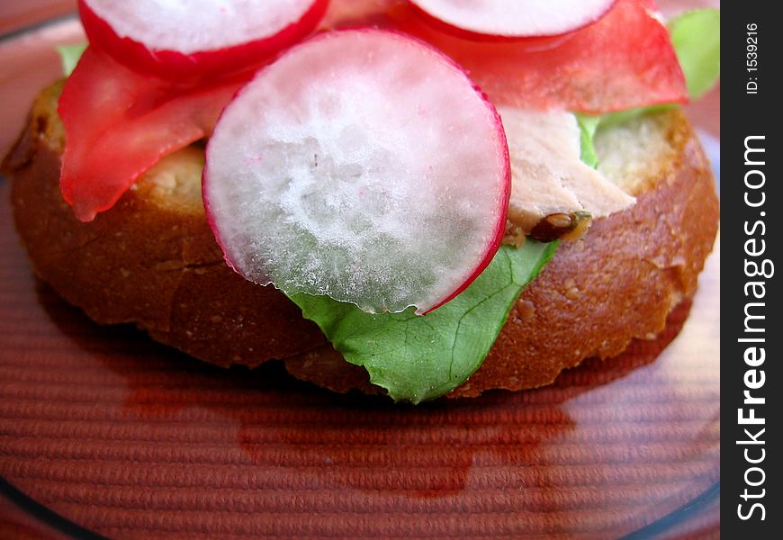 Fresh spring time sandwich:

bread, butter, lettuce, pork, tomato, radish