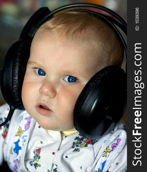 A photo of a baby in headphones