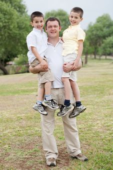 Father Carrying His Two Son In His Hands Royalty Free Stock Images
