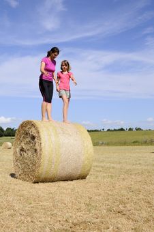 White People Playing Nature On Hay Bales Stock Photography White People Playing Nature On Hay Bales Stock Photography