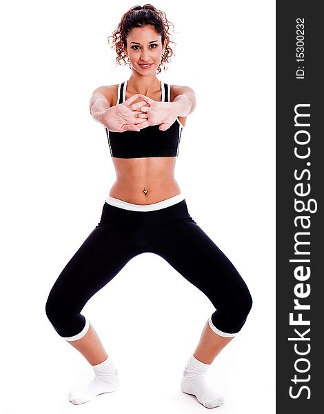 Cute fitness girl stretching her hands on isolated white background