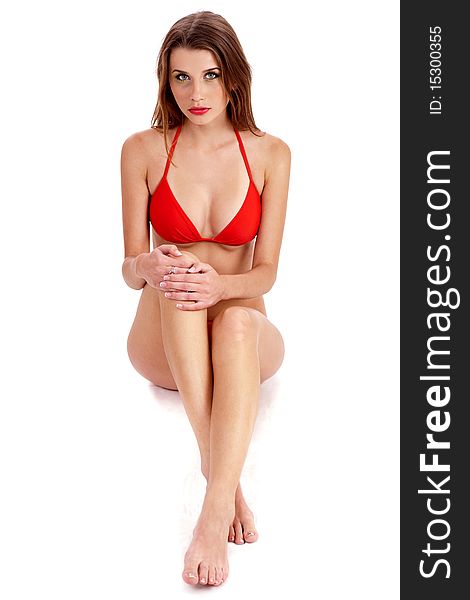 Young Pretty Woman In Red Bikini Sitting