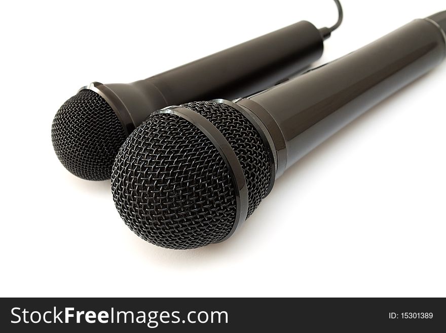 Two black microphones isolated on a white background.