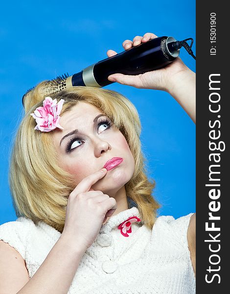 Young blond with hairdryer studio shot pin-up style. Young blond with hairdryer studio shot pin-up style