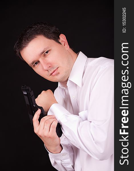 Caucasian man with weapon in his arm.  Black background. Caucasian man with weapon in his arm.  Black background.