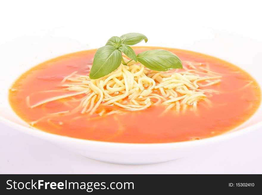 Tomato soup with macaroni decorated with basil