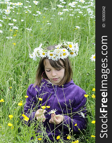 Caucasian girl with wreath flower playing in grass. Caucasian girl with wreath flower playing in grass