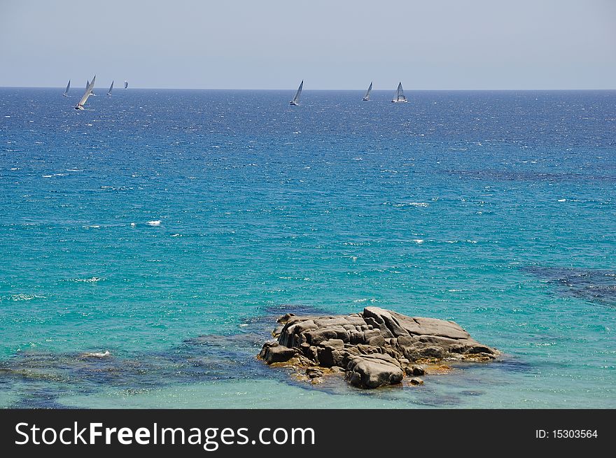 Race of sailboats in the beautiful sea of Sa Ruxi, Villasimius, in Sardinia, Italy. Race of sailboats in the beautiful sea of Sa Ruxi, Villasimius, in Sardinia, Italy.