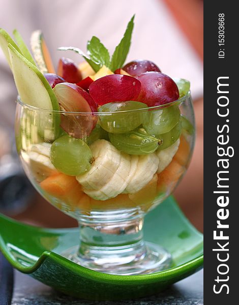 Mix of fruits in glass goblet. Summer dessert