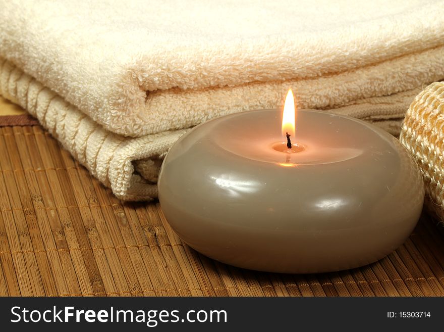 Soothing spaand wellness composition - candle and towels. Soothing spaand wellness composition - candle and towels