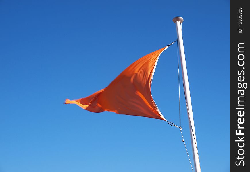 A shot of an orange banner signaling polluted or dangerous sea