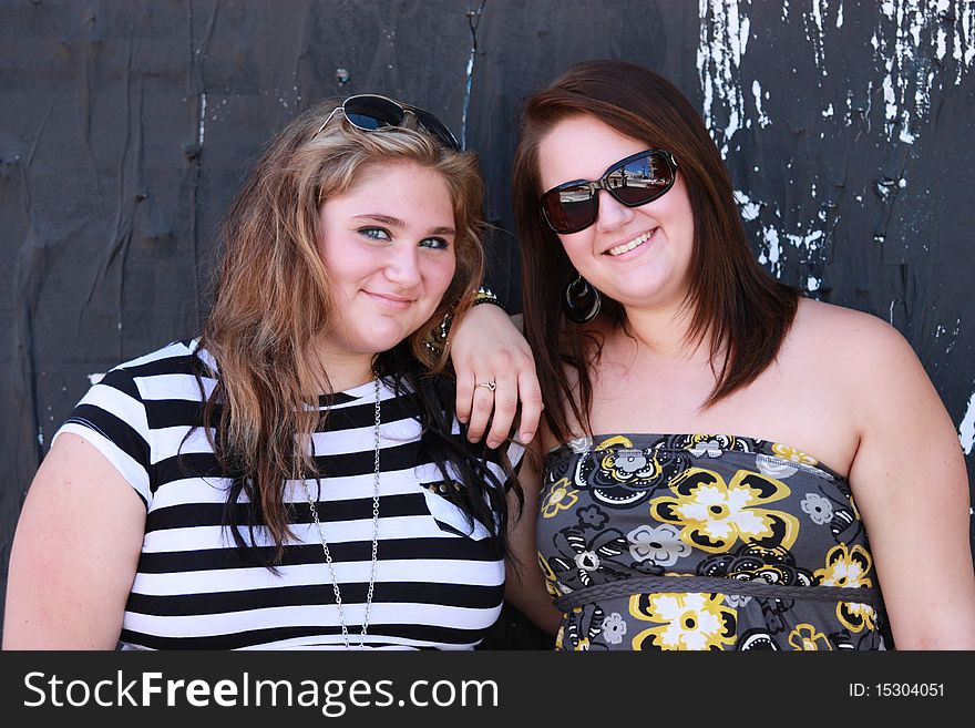 Portrait of 2 sisters against a grunge background. Portrait of 2 sisters against a grunge background