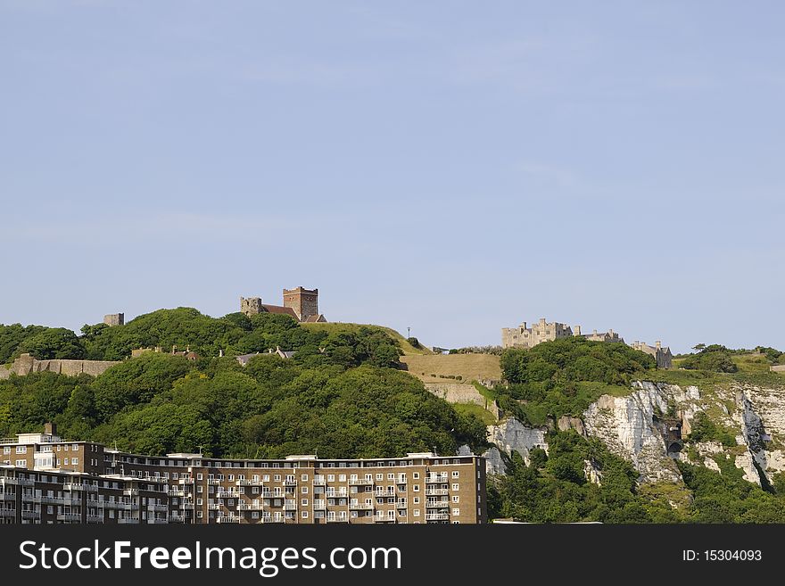 View with modern constructions and White Cliffs from UK, Dover Castle and blue sky in background. View with modern constructions and White Cliffs from UK, Dover Castle and blue sky in background