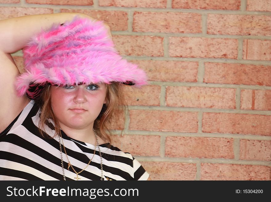 Teenager wearing a pink fur hat. Teenager wearing a pink fur hat