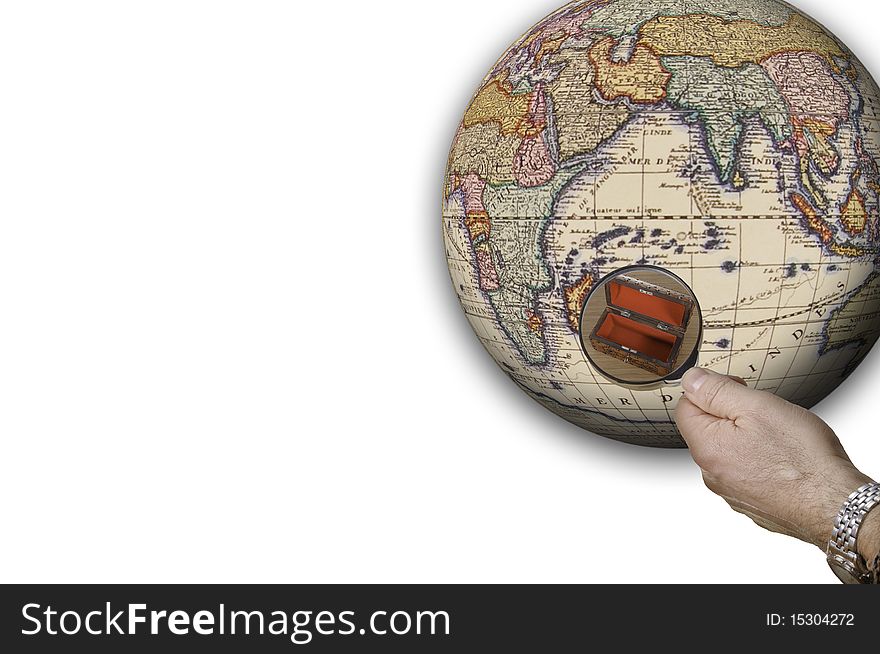 This image shows a globe. A hand with a magnifying glass shows a detail of the globe, namely an empty box. This image shows a globe. A hand with a magnifying glass shows a detail of the globe, namely an empty box.