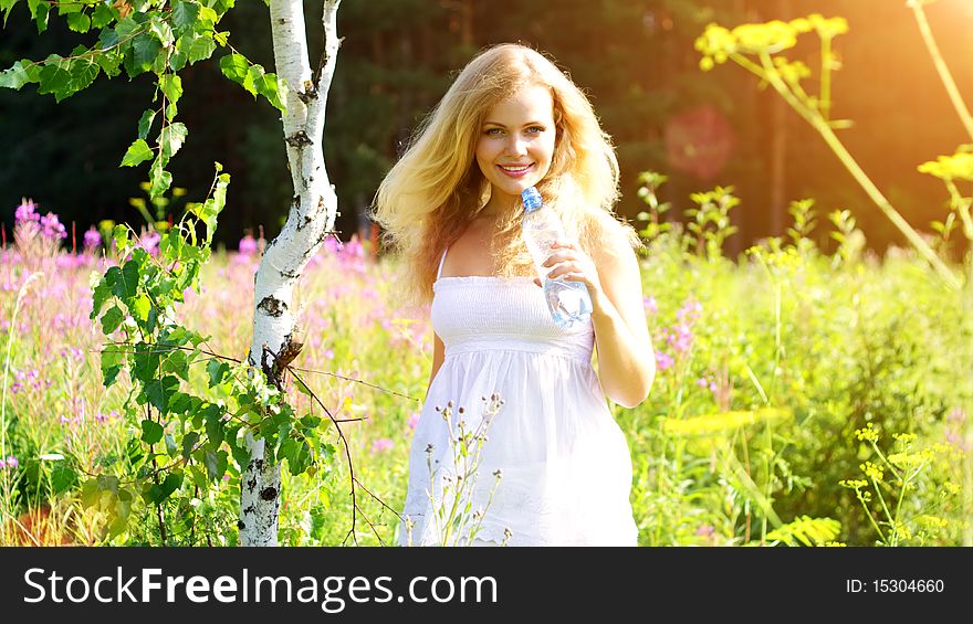 Beautiful girl holding a bottle of water