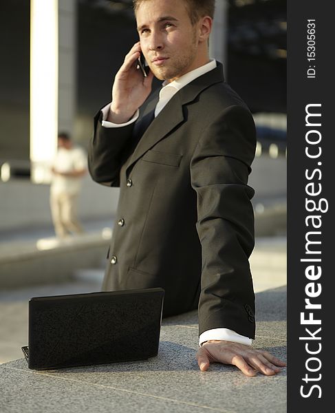 Businessman portrait with laptop and mobile phone. Businessman portrait with laptop and mobile phone