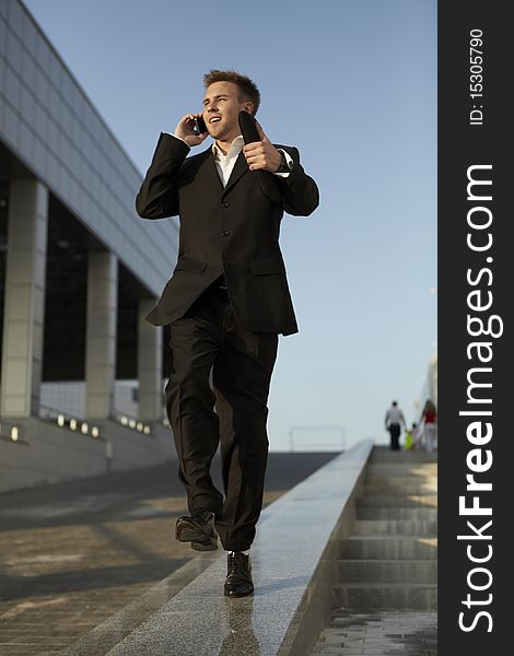 Young businessman calling on mobile phone, outdoor. Young businessman calling on mobile phone, outdoor.