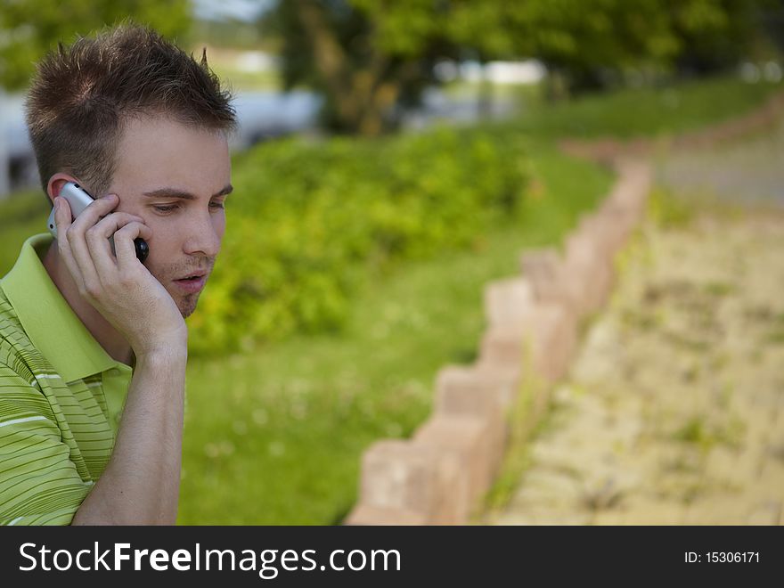 Cheerful guy in a green vest. Photo with copy-space.