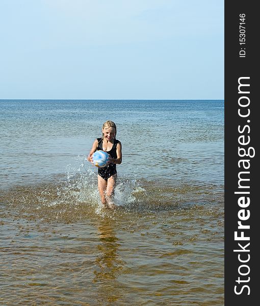 Running girl with ball on the water. Running girl with ball on the water.