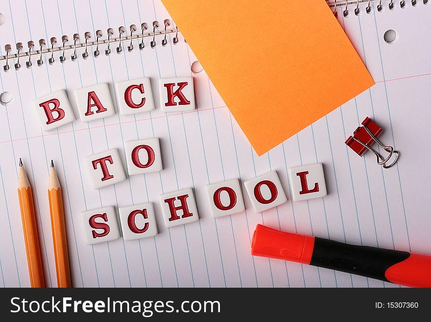 School writing-book with text Back to School and school subjects.