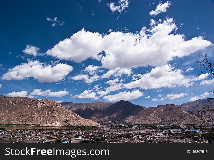 Lhasa city overview with great white cloudscape against blue sky