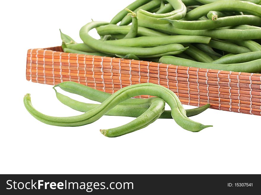 Young green French string bean in pods on a white background. Young green French string bean in pods on a white background.