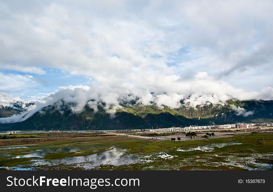 Mountain landscape with green trees covered and white cloudscape