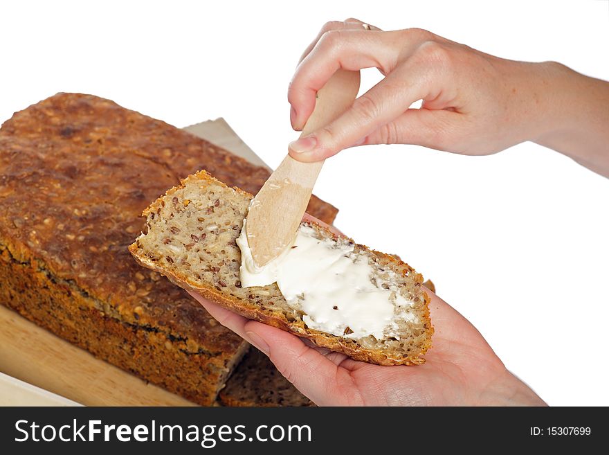 Hand bread slices on a board with a knife - white background