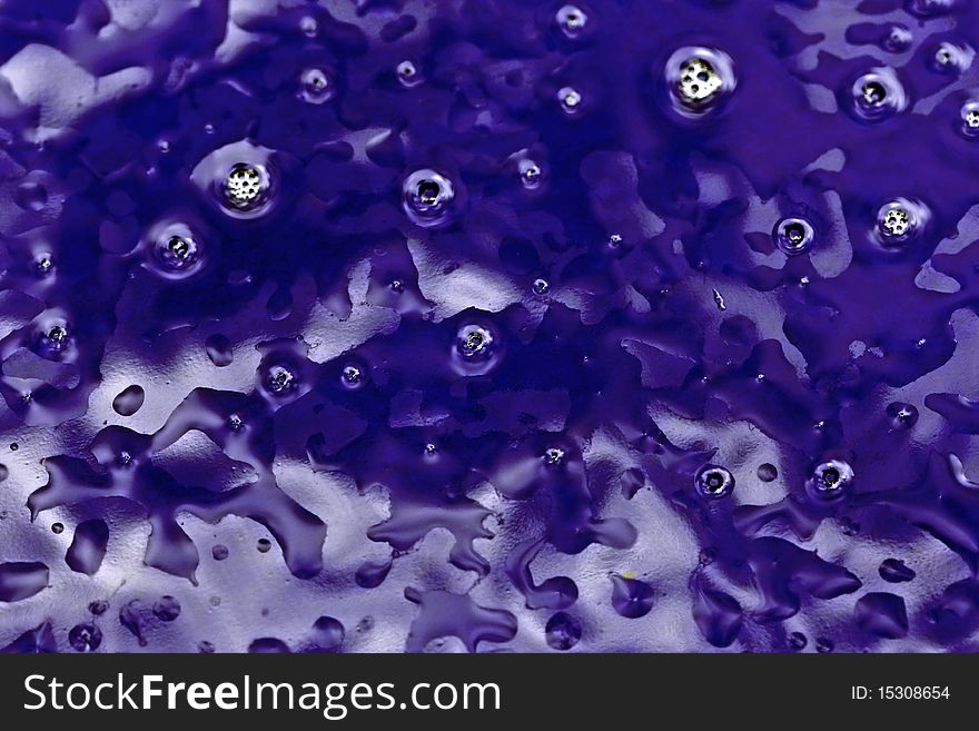 an abstract background of wet blue stained glass with light reflections. an abstract background of wet blue stained glass with light reflections