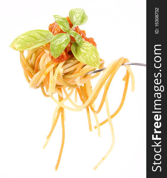 Spaghetti with sauce bolognese hanging on a fork decorated with fresh basil. Spaghetti with sauce bolognese hanging on a fork decorated with fresh basil