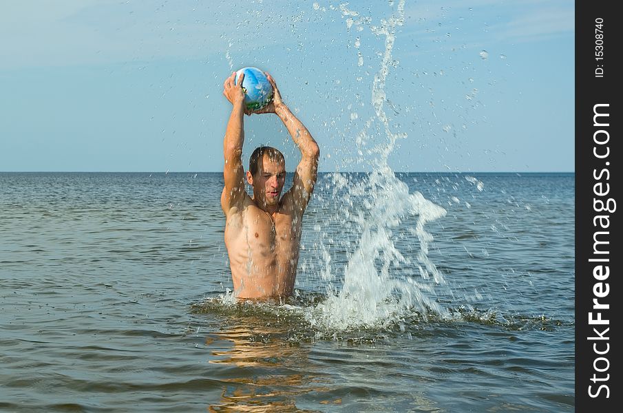 Man play with ball in the water. Man play with ball in the water.